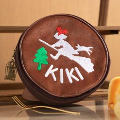 Round velour Kiki's Delivery Service pouch with embroidered Kiki and Jiji flying past a tree
