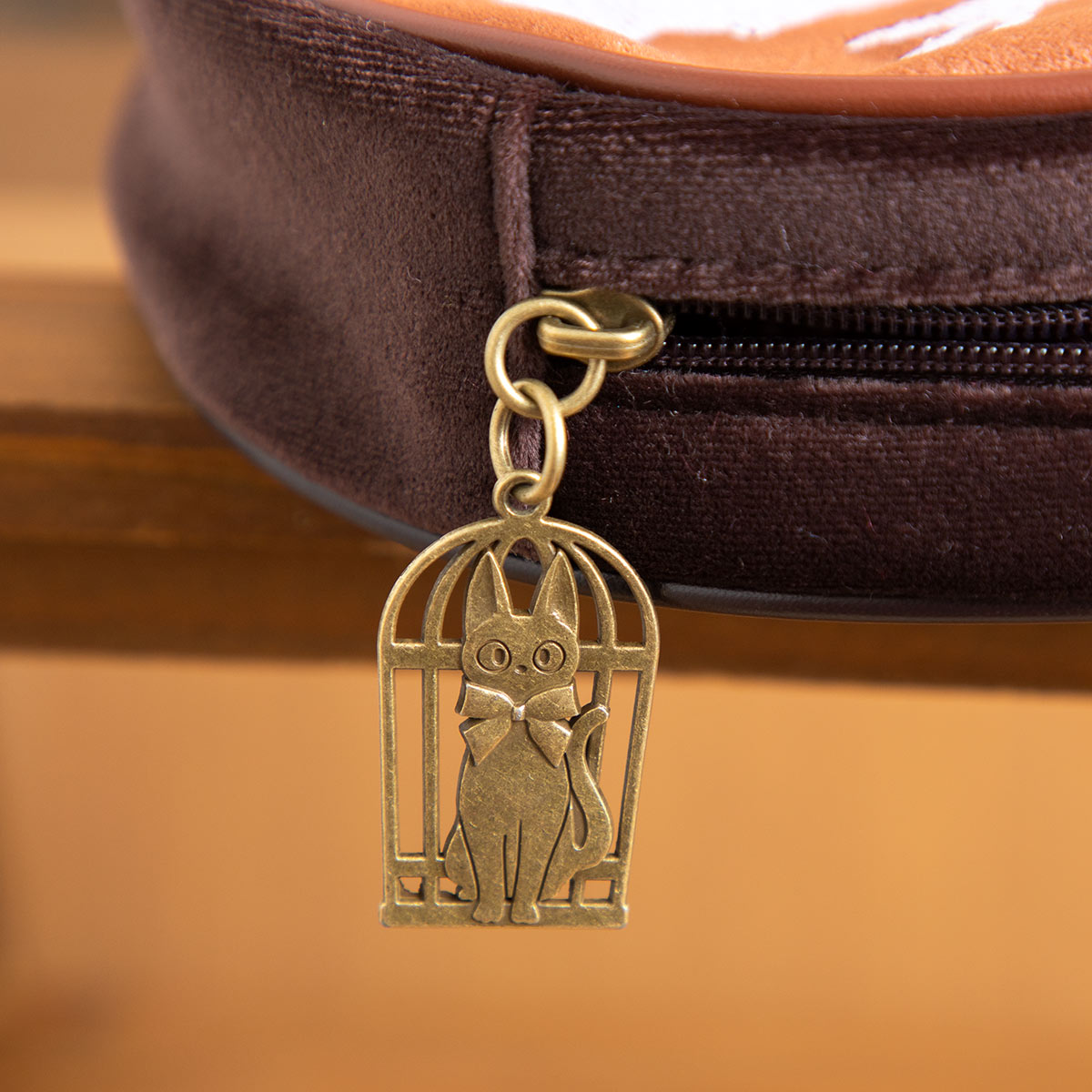 Brass Jiji in a birdcage zip charm on the Kiki's Delivery Service pouch