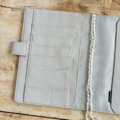 butterfly pattern in vibrant yellow, plus greys and browns, and a pale grey vegan 'leather' trim.