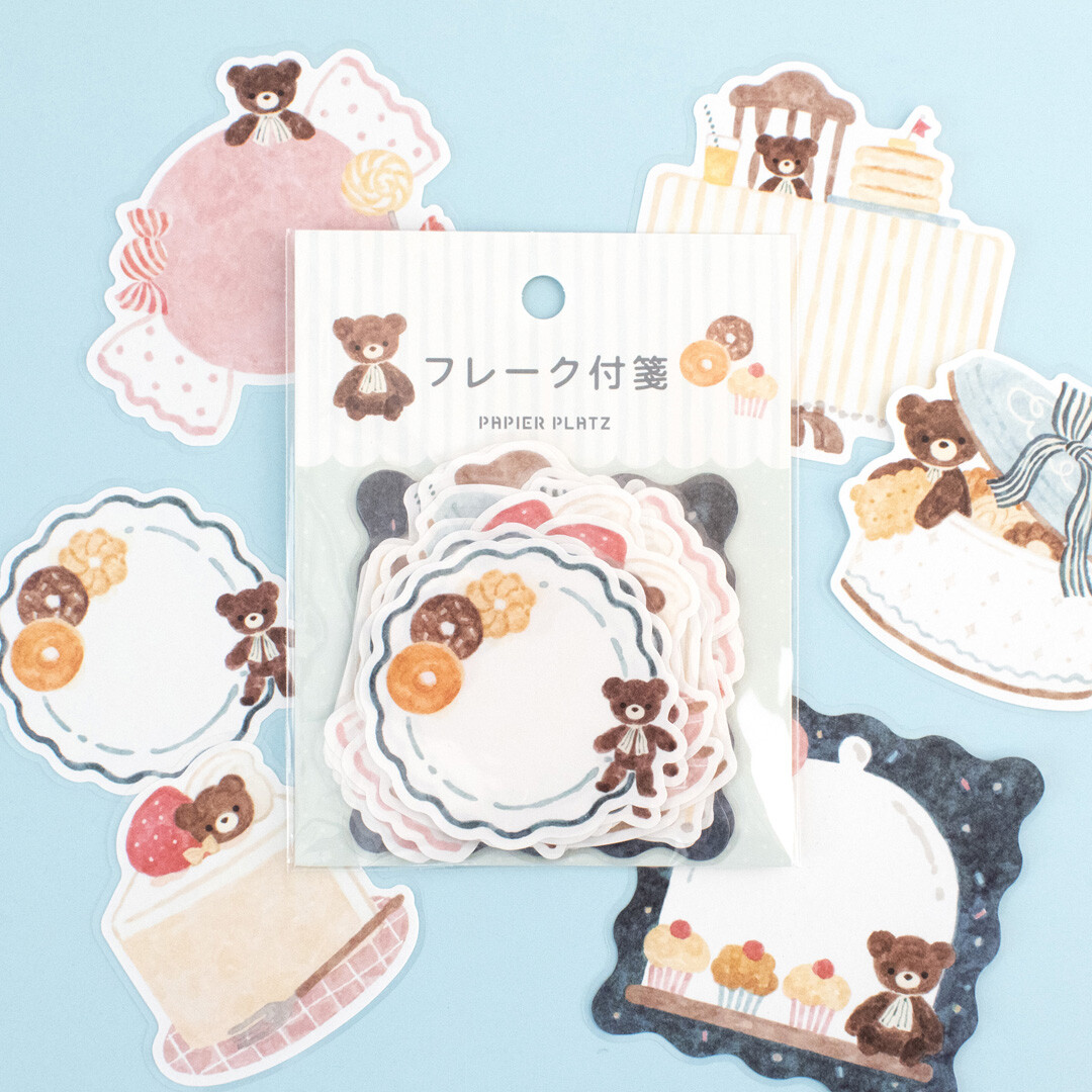 Papier Platz Bear Café sticker flakes packaged in a clear bag, showing teddy bear cake illustrations and dessert motifs designed by Nakauchiwaka.