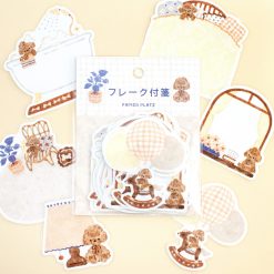 : Individual Papier Platz teddy bear stickers by Nakauchiwaka featuring beds, lamps, bathtubs, mirrors, and rocking horse illustrations on a yellow background.