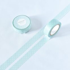 Aquamarine green polka dot washi tape by Papier Platz, photographed rolled with a matching unrolled strip.