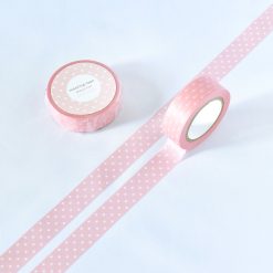 Soft pink polka dot washi tape by Papier Platz, shown rolled and unrolled on a white background.
