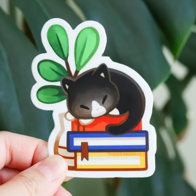 Thousand Skies Vinyl Sticker - Cat Napping On Books