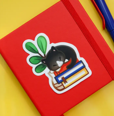 Thousand Skies Vinyl Sticker - Cat Napping On Books