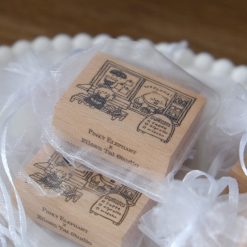 Styled photo of Eileen Tai “Bearista Café Daydream” rubber stamps in organza bags arranged together on a plate.