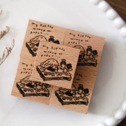Eileen Tai journal girl wooden rubber stamp shown with a stamped illustration on a paper tag.