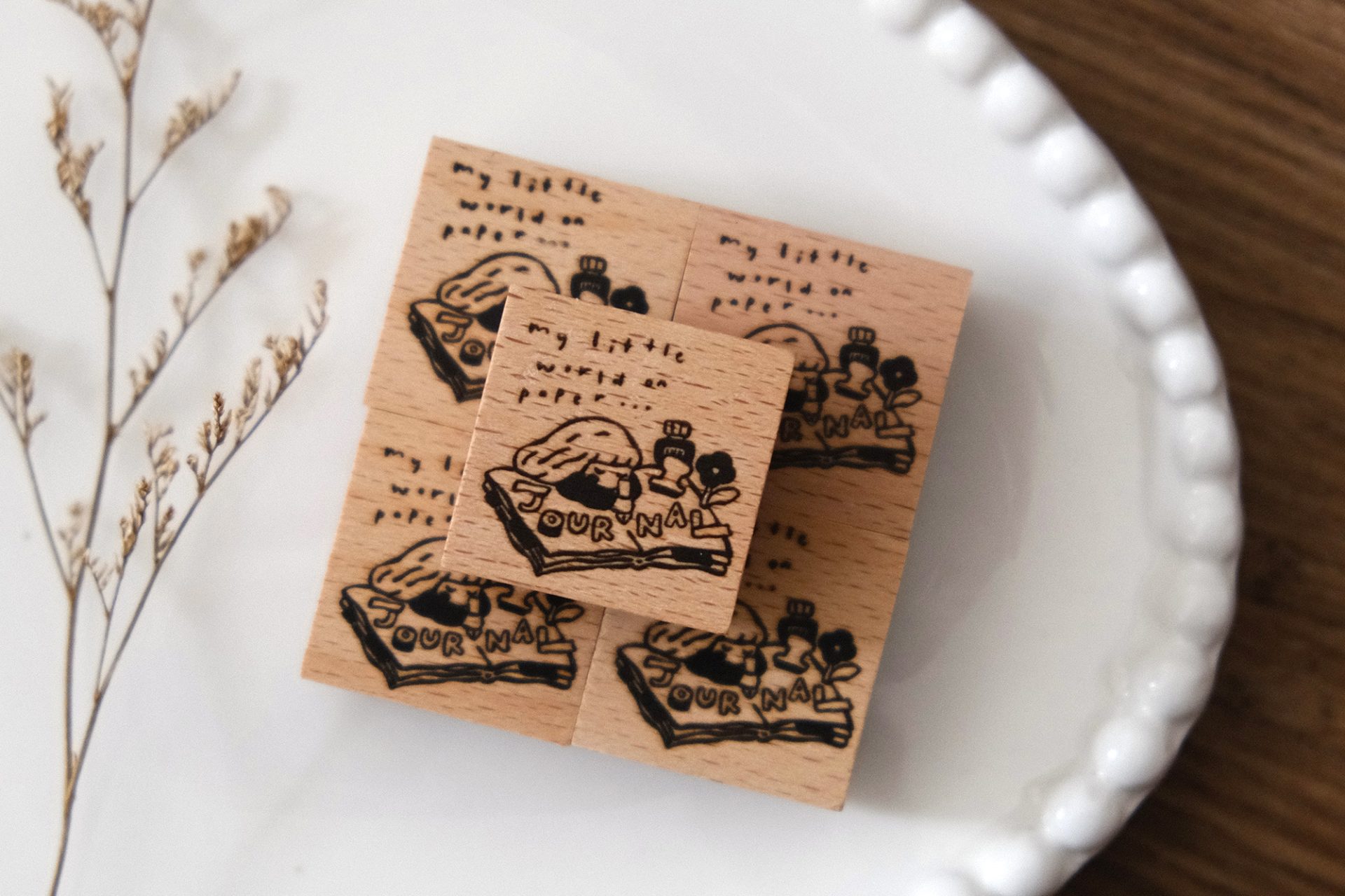 Eileen Tai journal girl wooden rubber stamp shown with a stamped illustration on a paper tag.