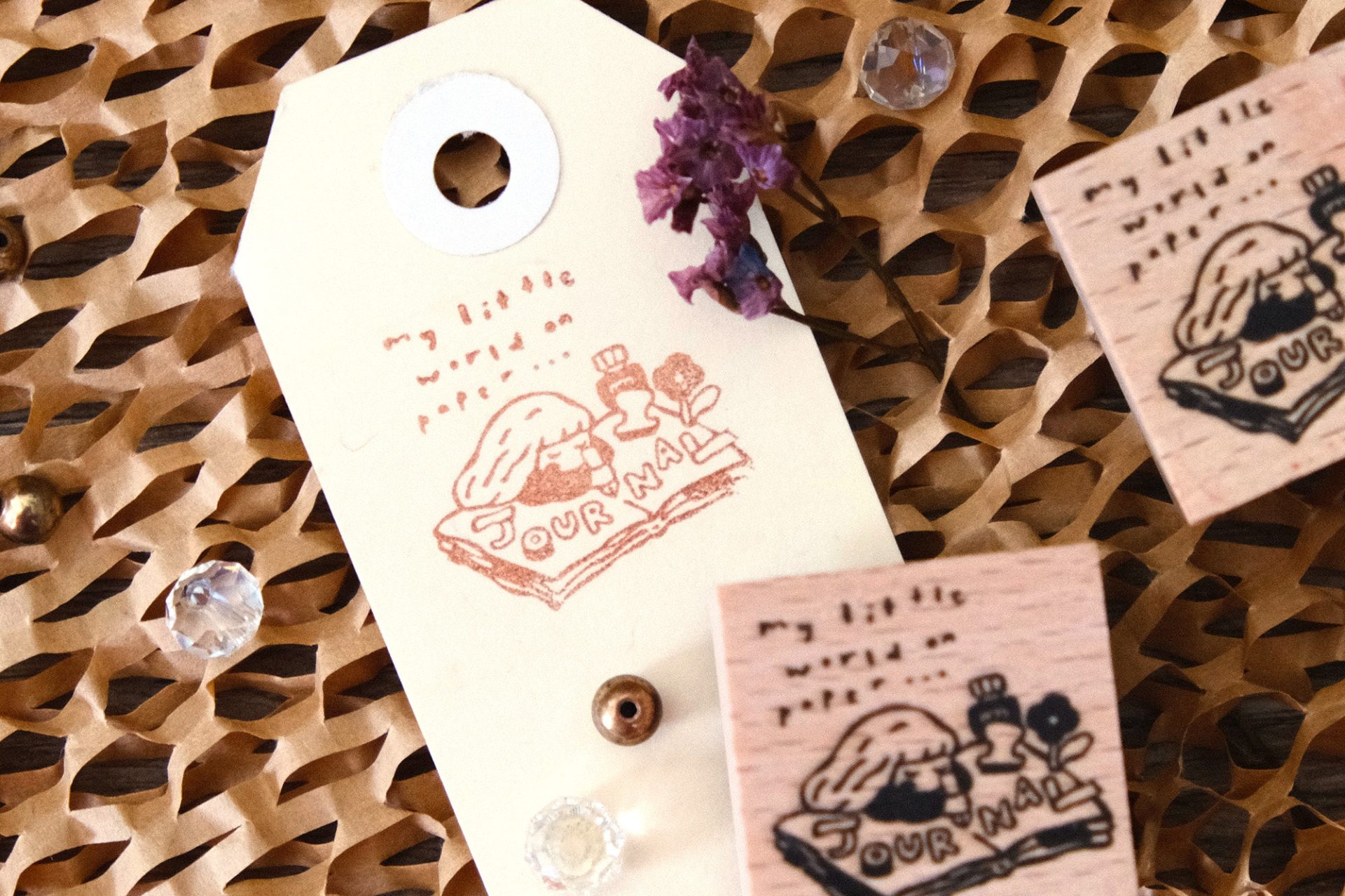 Flat lay of multiple Eileen Tai journal girl wooden rubber stamps arranged on a ceramic plate.