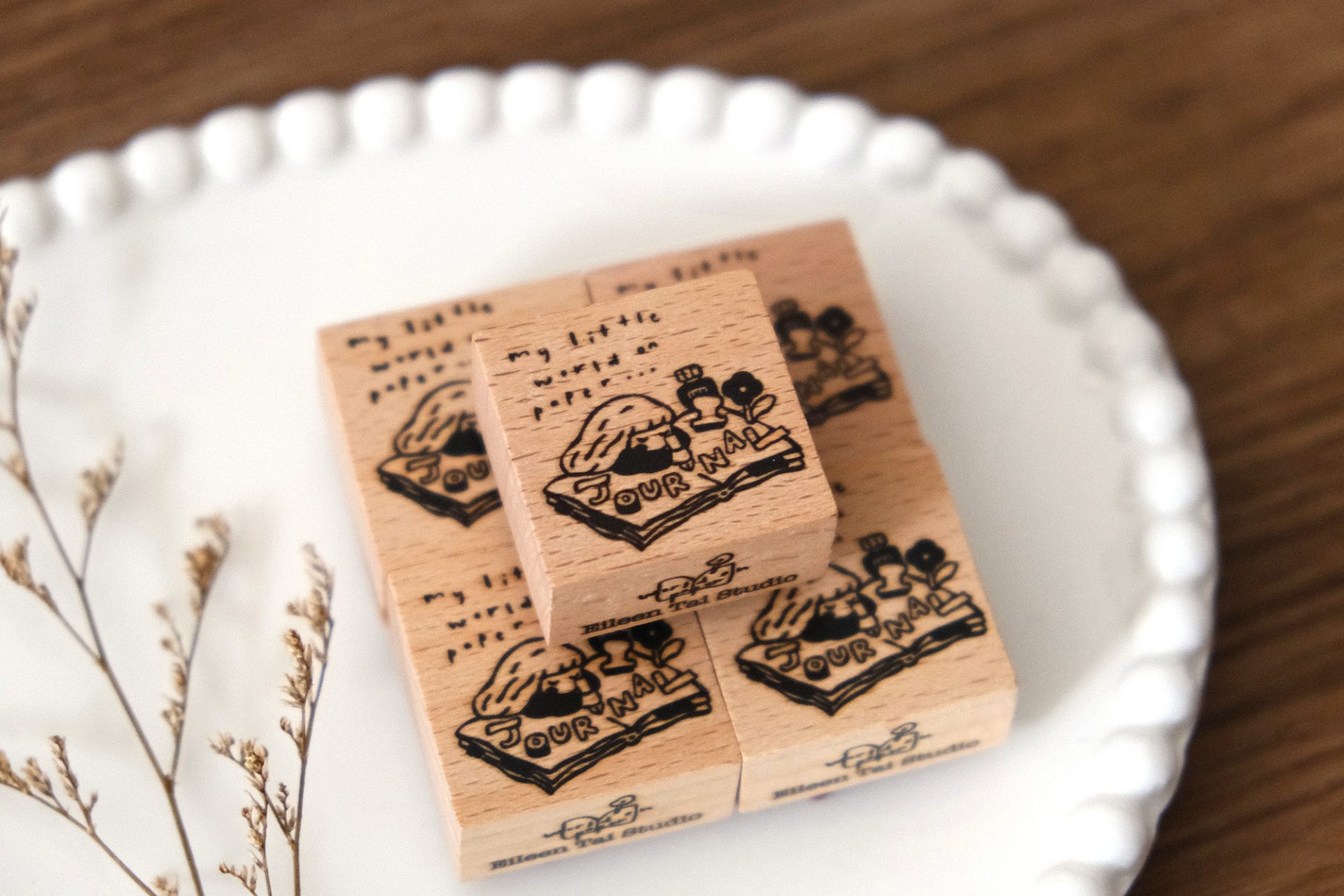 Journal girl illustration stamped on a paper tag using an Eileen Tai wooden rubber stamp.