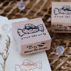 Flat lay of multiple Sweet Like Candy wooden rubber stamps arranged on a ceramic plate.