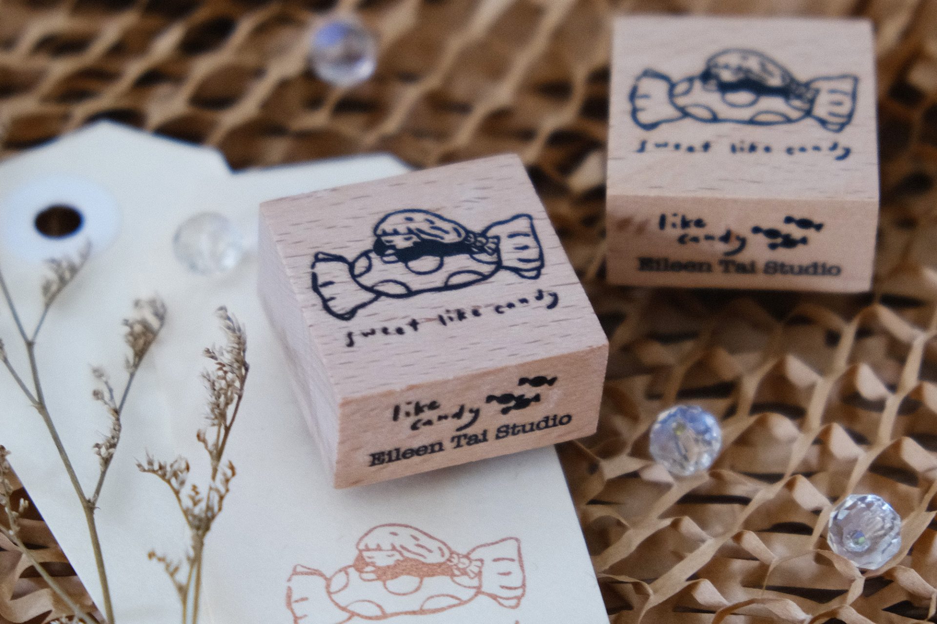 Flat lay of multiple Sweet Like Candy wooden rubber stamps arranged on a ceramic plate.