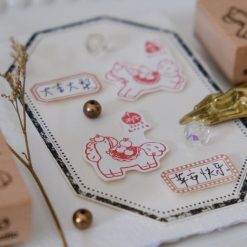 Close-up of the Eileen Tai Year of the Horse wooden rubber stamp featuring an apple-themed horse design.