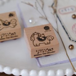 Styled view of Eileen Tai Year of the Horse rubber stamps with apple-themed horse illustrations and stamped details.
