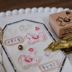Angled close-up of the Eileen Tai Year of the Horse rubber stamp with pear-themed stamped illustrations.