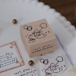 Cloudy day illustration stamped from the Let’s Play wooden weather stamp, shown in a styled flat lay.