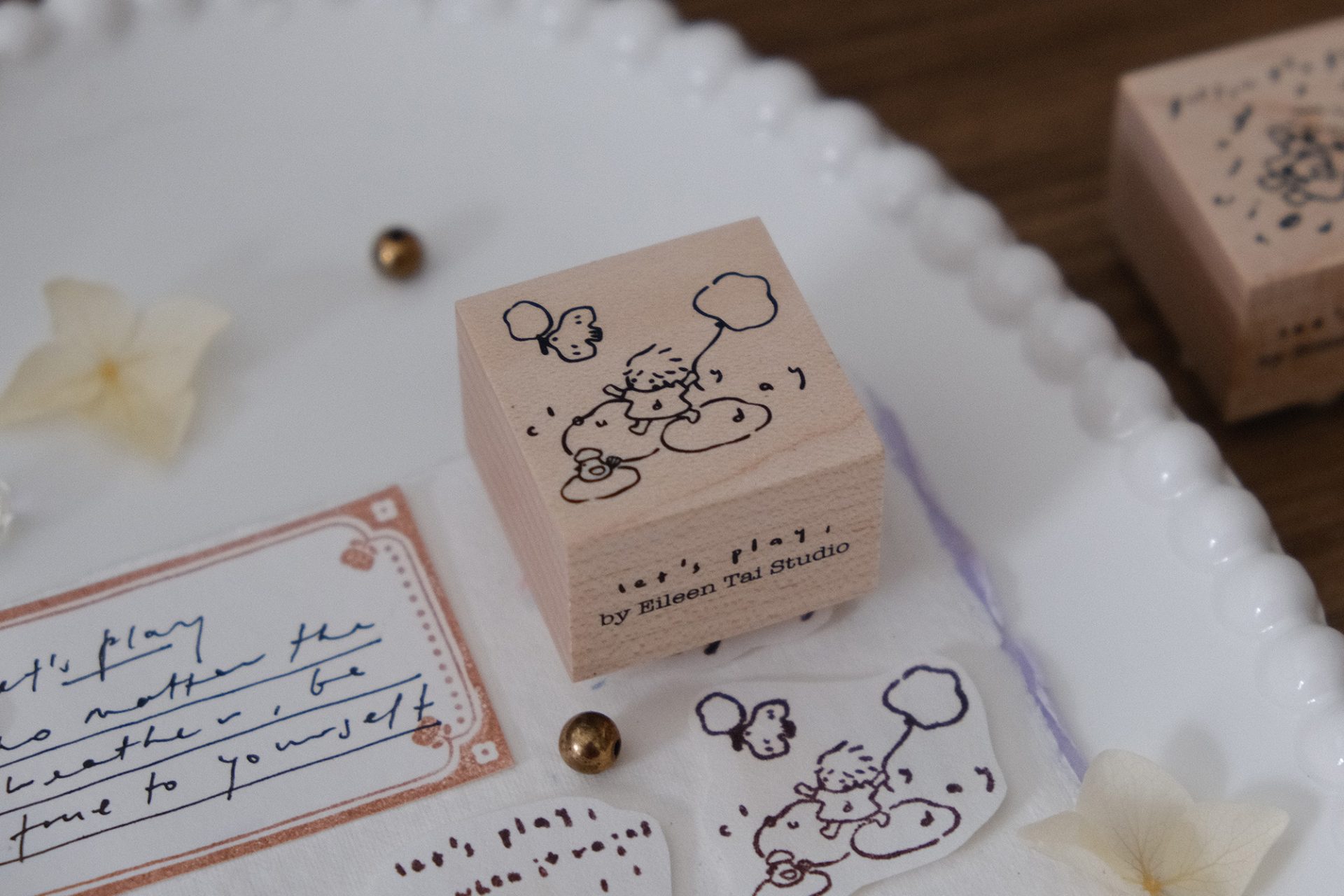 Cloudy day illustration stamped from the Let’s Play wooden weather stamp, shown in a styled flat lay.