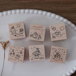 Full Let’s Play weather-themed wooden stamp set arranged together on a ceramic plate.