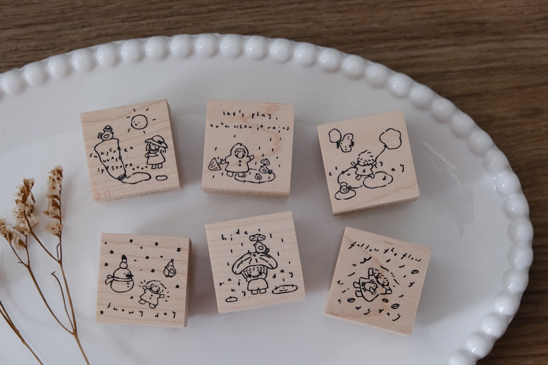 Let’s Play weather-themed wooden stamps shown as stamped impressions in a journaling layout.