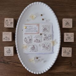 Flat lay of the full Let’s Play weather-themed wooden stamp set arranged on a ceramic tray.