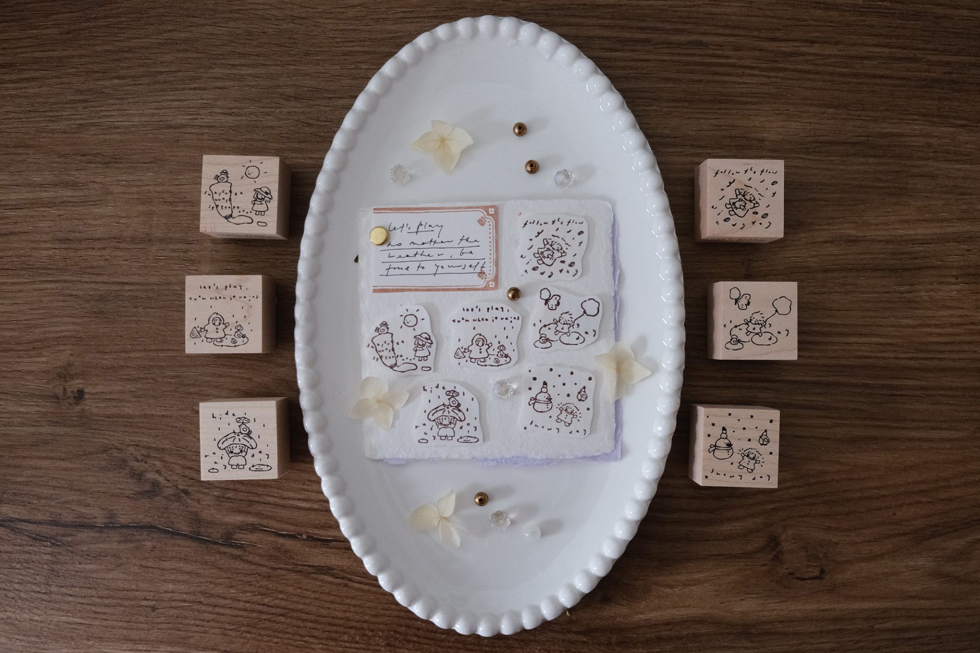 Flat lay of the full Let’s Play weather-themed wooden stamp set arranged on a ceramic tray.