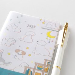 Close up of the Midori 2027 Mini Pocket Diary Dog cover with a pen