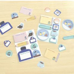 Papier Platz mini sticky notes from the Eric Small Things stationery collection laid out flat showing all small sticky note shapes and designs on a light wood background.