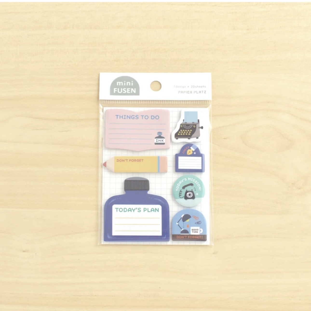 Papier Platz Eric Small Things mini sticky notes in original packaging, showing stationery-themed mini shapes including ink bottles, typewriters, and memo labels on a wooden background.
