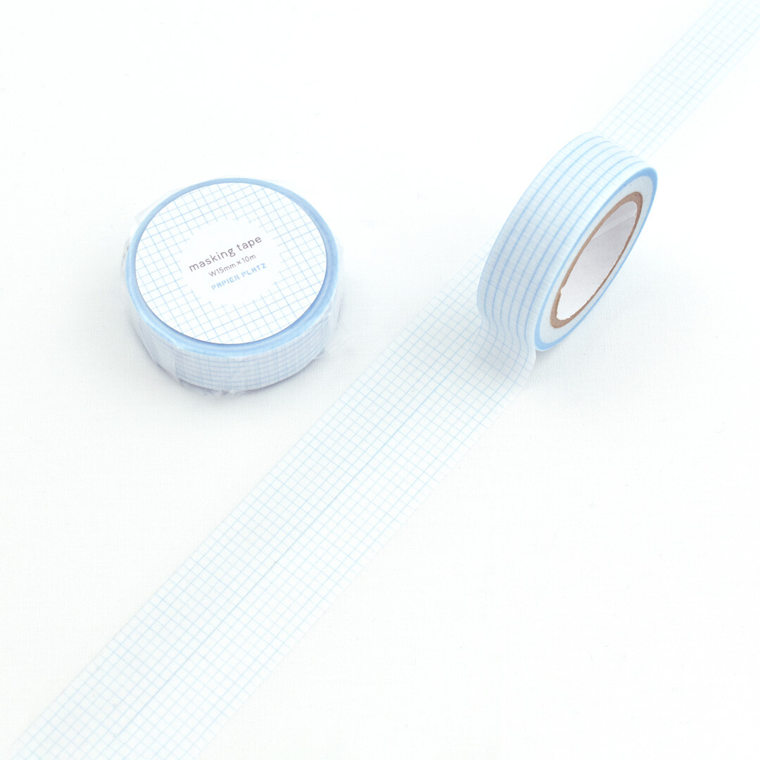 Blue Papier Platz grid masking tape roll unrolled to show fine grid lines on white background.