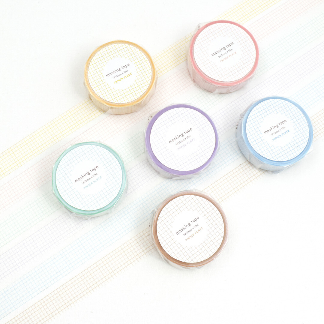 Papier Platz grid masking tape rolls in multiple pastel colours arranged on a white background with unrolled tape strips.
