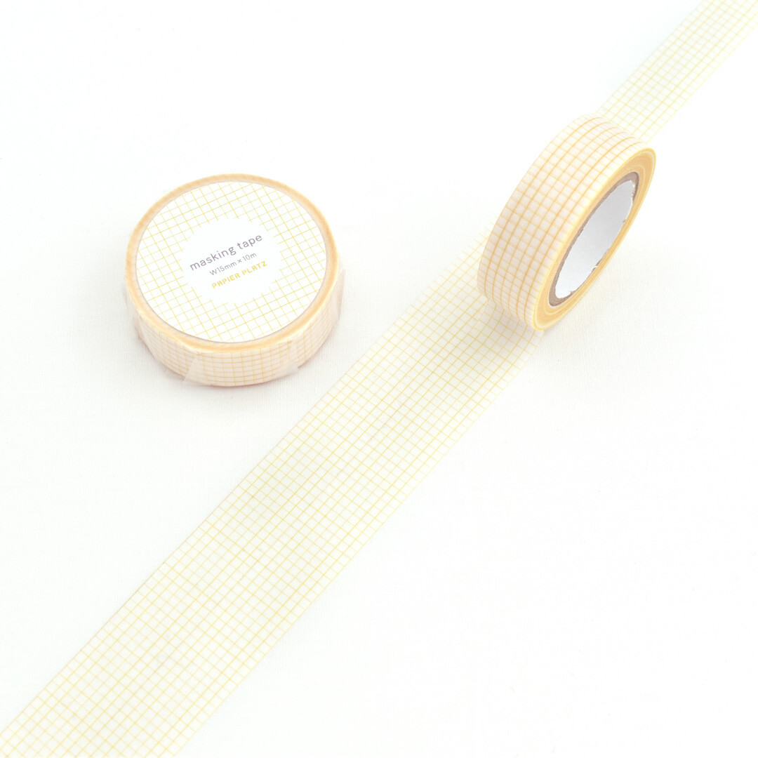 Yellow Papier Platz grid masking tape roll shown unrolled on a white background.