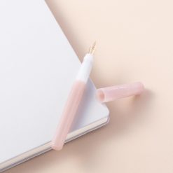 Pilot Kakuno Madoromi fountain pen in Pink, uncapped beside its cap on a notebook